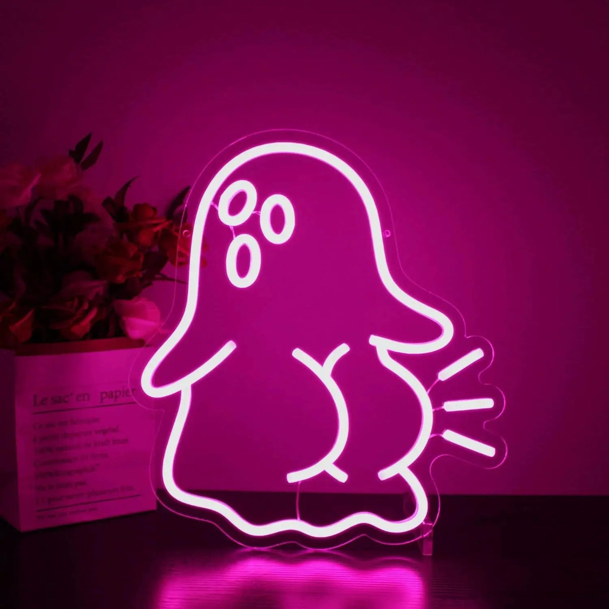 Cute ghost neon sign glowing in hot pink on clear acrylic backing